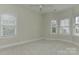 Bedroom with soft carpet, bright natural light, and a ceiling fan at 17210 Sulky Plough Rd # 1206, Charlotte, NC 28277