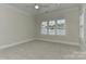 A bright bedroom featuring neutral walls, carpet, recessed lighting, and a window at 17210 Sulky Plough Rd # 1206, Charlotte, NC 28277