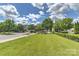 Beautifully landscaped community area, featuring green grass and mature trees at 17210 Sulky Plough Rd # 1206, Charlotte, NC 28277