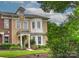 Charming home boasts a mix of brick and stucco, complemented by lush greenery and a well-manicured lawn at 17210 Sulky Plough Rd # 1206, Charlotte, NC 28277