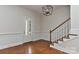 Open foyer featuring hardwood floors, elegant wainscoting, and a staircase with wooden banister at 17210 Sulky Plough Rd # 1206, Charlotte, NC 28277