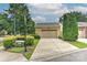 Attached garage with a concrete driveway and a well-manicured lawn at 17210 Sulky Plough Rd # 1206, Charlotte, NC 28277