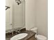 Half bathroom featuring granite countertop and a decorative mirror above the sink at 17210 Sulky Plough Rd # 1206, Charlotte, NC 28277