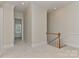 Hallway with wood staircase, neutral walls, crown molding, and an open doorway at 17210 Sulky Plough Rd # 1206, Charlotte, NC 28277