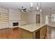 Open-concept layout with granite island, fireplace, and access to outdoor living at 17210 Sulky Plough Rd # 1206, Charlotte, NC 28277