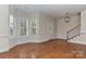 Spacious living room featuring hardwood floors, classic wainscoting, and plenty of natural light at 17210 Sulky Plough Rd # 1206, Charlotte, NC 28277
