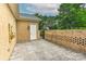 A stamped concrete patio with brick wall and a white door to the building at 17210 Sulky Plough Rd # 1206, Charlotte, NC 28277