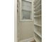 Bright walk-in closet with built-in shelving and natural light from a window at 17210 Sulky Plough Rd # 1206, Charlotte, NC 28277