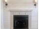 A cozy fireplace with mantle, shiplap surround, and sconces at 1743 Silver Stream Dr, Rock Hill, SC 29730