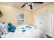 Comfortable bedroom featuring a window, double closet, plush bedding, and a decorative ceiling fan at 1957 8Th Street Se Ln, Hickory, NC 28602