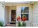 Welcoming front entrance featuring a storm door and vibrant red lilies at 1957 8Th Street Se Ln, Hickory, NC 28602