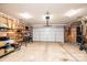 Spacious garage with a roll-up door, concrete floor, overhead lighting, and built-in shelving at 1957 8Th Street Se Ln, Hickory, NC 28602