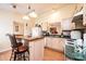Well-lit kitchen features a breakfast bar, light wood cabinets, and modern appliances at 1957 8Th Street Se Ln, Hickory, NC 28602