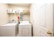 Functional laundry room equipped with a washer, dryer, and ample shelving for storage at 1957 8Th Street Se Ln, Hickory, NC 28602