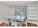 Bright dining area with natural light, built in shelving, and a white table set for four with upholstered chairs at 2005 Schofield Pl, Salisbury, NC 28144