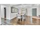 Bright dining room featuring dark wood floors, a wooden dining table, and a decorative mirror at 2005 Schofield Pl, Salisbury, NC 28144