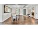 Bright dining room with wood floors, a large mirror, and a view to the entry foyer at 2005 Schofield Pl, Salisbury, NC 28144