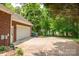 Long paved driveway leading to a spacious garage, complemented by lush greenery at 2005 Schofield Pl, Salisbury, NC 28144
