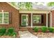 Charming brick home with lush landscaping and inviting front porch with white pillars at 2005 Schofield Pl, Salisbury, NC 28144
