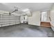Large garage space with neutral flooring, garage door, and convenient access door at 2005 Schofield Pl, Salisbury, NC 28144