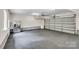 Spacious two-car garage featuring clean flooring, stainless steel refrigerator, and ample storage space at 2005 Schofield Pl, Salisbury, NC 28144