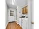 Laundry room with updated washer and dryer, wood-look floors, and direct access to the exterior at 2005 Schofield Pl, Salisbury, NC 28144