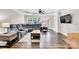Bright living room featuring a grey sectional sofa, hardwood floors, and built-in shelves at 2005 Schofield Pl, Salisbury, NC 28144