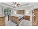 Spacious main bedroom featuring a trey ceiling, a ceiling fan, a large window, and rustic wood furnishings at 2005 Schofield Pl, Salisbury, NC 28144