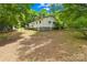 Home's back elevation with porch and partial basement at 208 Lipe Rd, Troutman, NC 28166