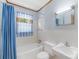 Functional bathroom with blue accents, including the shower curtain and window curtain at 208 Lipe Rd, Troutman, NC 28166
