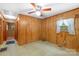 Cozy bedroom with wood paneling, natural light, and hardwood style flooring at 208 Lipe Rd, Troutman, NC 28166