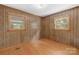 Bedroom featuring wood paneling, natural light, and hardwood style flooring at 208 Lipe Rd, Troutman, NC 28166