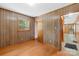 Bedroom featuring wood paneling, natural light, and hardwood style flooring at 208 Lipe Rd, Troutman, NC 28166