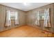 Cozy bedroom with wood paneling, natural light, and hardwood style flooring at 208 Lipe Rd, Troutman, NC 28166
