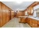 Kitchen featuring wood cabinets, vintage countertops, and linoleum flooring at 208 Lipe Rd, Troutman, NC 28166