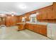 Functional kitchen featuring wood cabinets, vintage countertops, and linoleum flooring at 208 Lipe Rd, Troutman, NC 28166