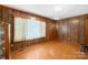 Cozy living room with wood paneled walls and hardwood floors at 208 Lipe Rd, Troutman, NC 28166