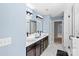 Modern bathroom with double vanity, black cabinets, a tile floor, and a glass enclosed shower at 2213 Iron Works Dr, Clover, SC 29710