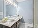 Modern bathroom with lighted mirror, marble countertop, floating vanity with bowl sink, and neutral walls at 2213 Iron Works Dr, Clover, SC 29710