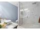 Modern bathroom with marble shower, floating vanity with bowl sink, and neutral walls at 2213 Iron Works Dr, Clover, SC 29710