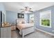 Bedroom with neutral walls featuring a full bed, ceiling fan, and two windows at 2213 Iron Works Dr, Clover, SC 29710