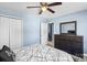 Bedroom with neutral walls featuring a queen bed, ceiling fan, dresser, and closet at 2213 Iron Works Dr, Clover, SC 29710