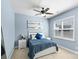 Bedroom with blue walls featuring a queen bed, ceiling fan, and two windows at 2213 Iron Works Dr, Clover, SC 29710
