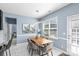 Stylish dining area with wood table, modern light fixture, and a view to the backyard at 2213 Iron Works Dr, Clover, SC 29710