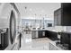 Modern kitchen with a waterfall island, sleek black cabinets, and stainless steel appliances at 2213 Iron Works Dr, Clover, SC 29710