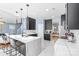 Modern kitchen with a waterfall island, sleek black cabinets, and stainless steel appliances at 2213 Iron Works Dr, Clover, SC 29710