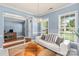 Bright living room with a white couch, chandelier, and many windows providing natural light at 2213 Iron Works Dr, Clover, SC 29710