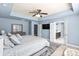 Spacious main bedroom with a king bed, tray ceiling, and access to the ensuite bathroom at 2213 Iron Works Dr, Clover, SC 29710