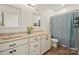 Neutral bathroom with double sinks, large mirrors, and a shower-tub combo with neutral colored curtain at 240 Bells Crossing Dr, Mooresville, NC 28117