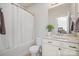 This bathroom has a tub with shower, white vanity and granite countertop, and a view to the bedroom at 240 Bells Crossing Dr, Mooresville, NC 28117